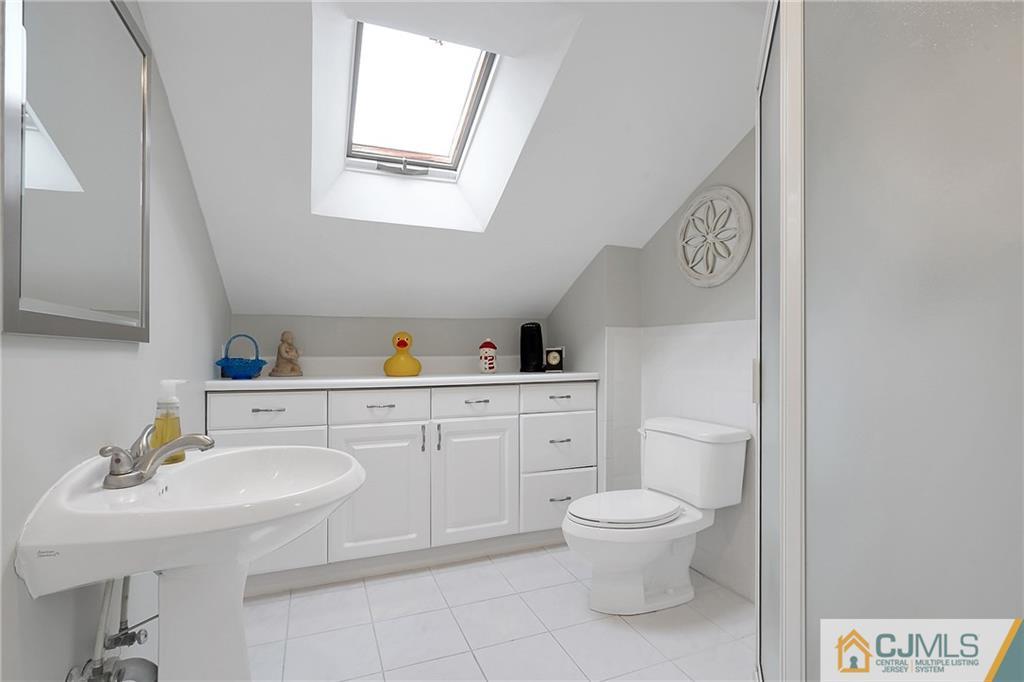 6 Meyer Road Edison, NJ 08817 - Photo 17 of 32 a bathroom with a toilet sink and mirror