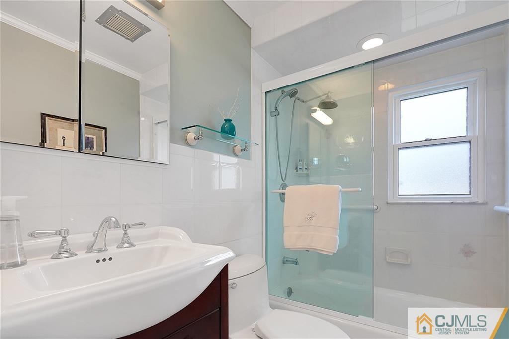 6 Meyer Road Edison, NJ 08817 - Photo 18 of 32 a bathroom with a sink a toilet and shower
