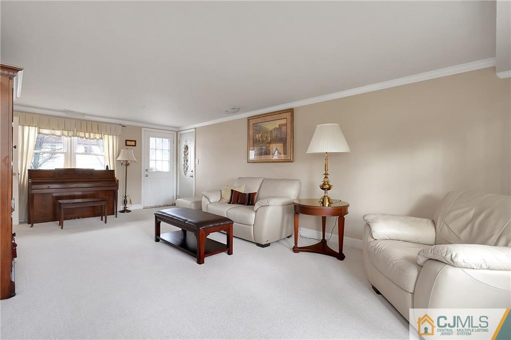 6 Meyer Road Edison, NJ 08817 - Photo 21 of 32 a living room with furniture and a lamp