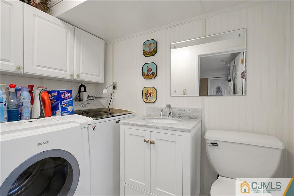 6 Meyer Road Edison, NJ 08817 - Photo 23 of 32 a bathroom with a sink a toilet and a mirror
