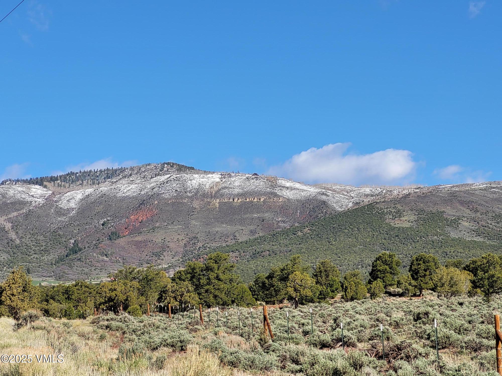 a view of a large mountain with mountains in the background