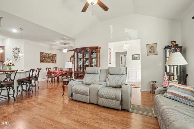 a living room with furniture and a potted plant