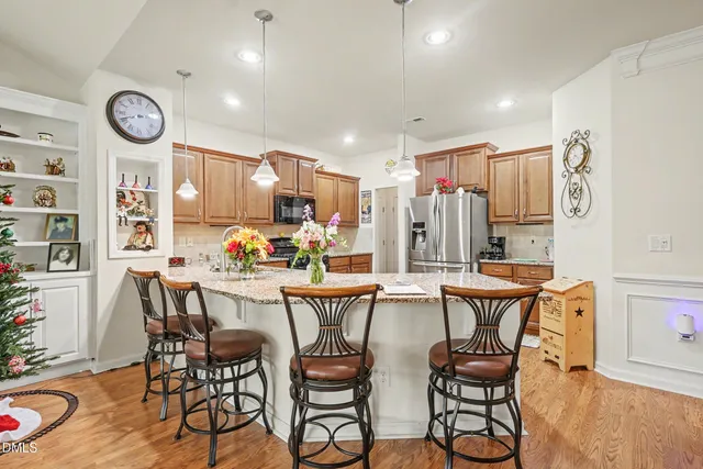 a kitchen with stainless steel appliances granite countertop a stove top oven a sink dishwasher and a microwave oven with cabinets