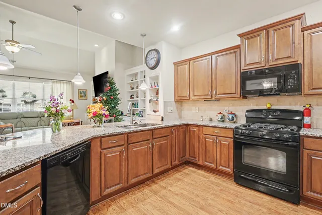 a kitchen with stainless steel appliances granite countertop a refrigerator and a sink