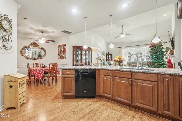 a kitchen with stainless steel appliances granite countertop a refrigerator stove and sink