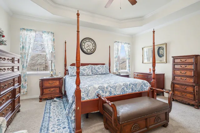 a bedroom with a bed and dresser with mirror