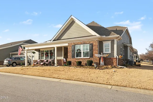 a front view of a house with large garden and outdoor seating