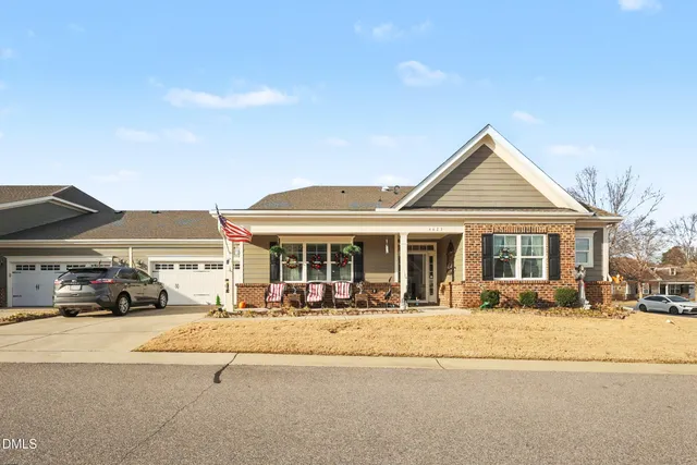 a front view of a building with cars parked