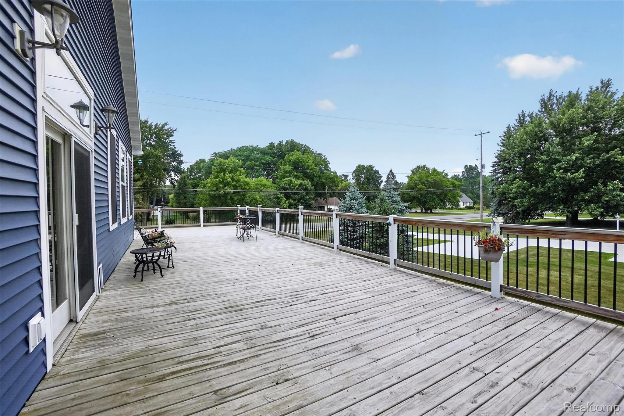 6524 Kelly Road Flushing, MI 48433 - Photo 41 of 47 Expansive wood deck featuring white railings with black balusters, providing ample outdoor space