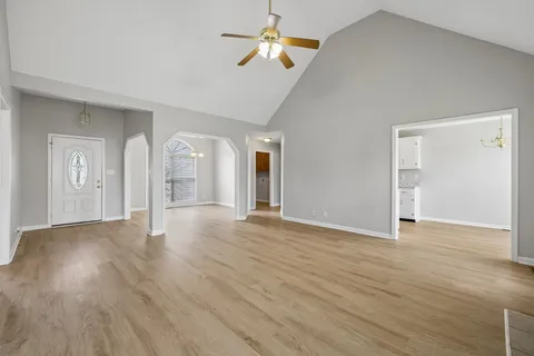 wooden floor fireplace and windows in an empty room