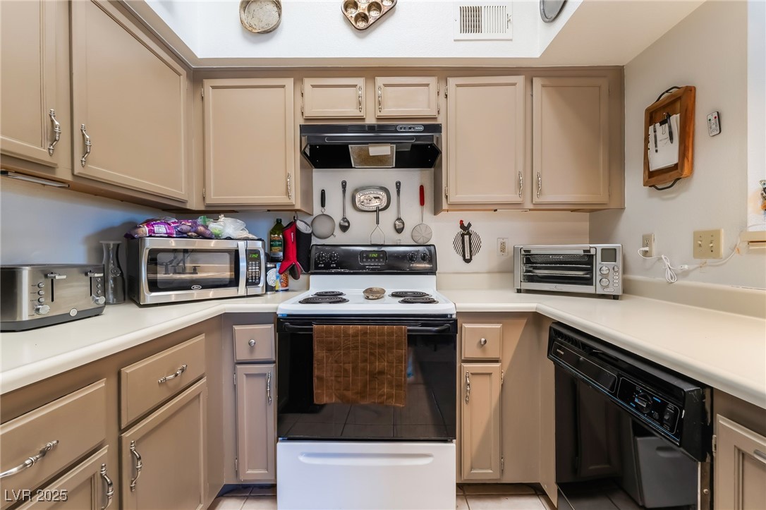 1575 West Warm Springs Road, Unit 2822 Henderson, NV 89014 - Photo 19 of 37 Kitchen with exhaust hood, electric stove, dishwasher, stainless steel microwave, and light countertops
