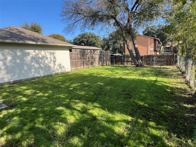a view of a backyard with a garden and plants
