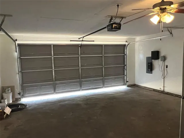 a view of an empty room with a ceiling fan