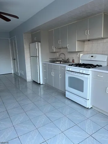 a kitchen with a stove top oven cabinets and stainless steel appliances