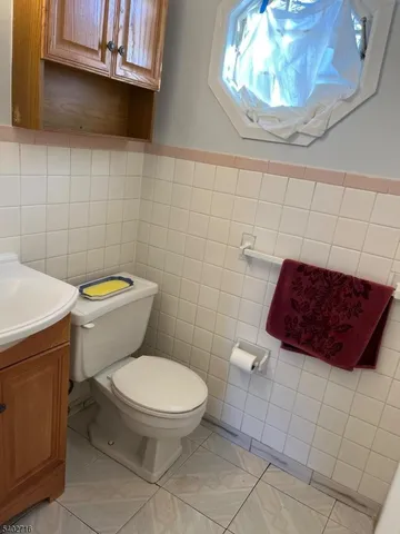 a bathroom with a toilet and a mirror