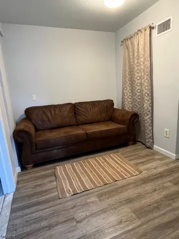 a living room with a couch and a rug