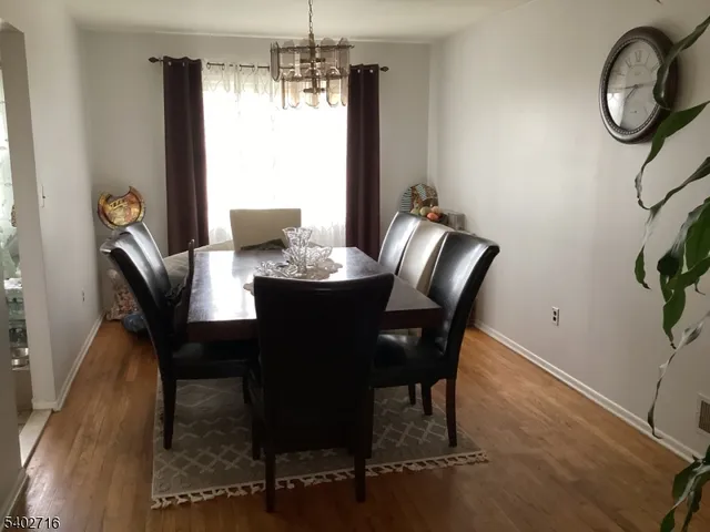 a dining room with furniture a chandelier and window