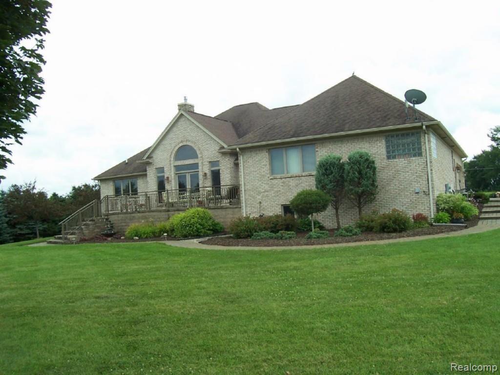 14470 Hough Road Allenton, MI 48002 - Photo 32 of 39 back view of home showing yard and landscaping