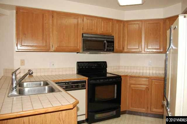 625 Talus Way Reno, NV 89503 - Photo 2 of 13 a kitchen with granite countertop a stove and a sink