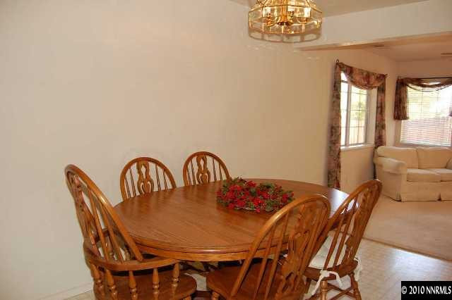 625 Talus Way Reno, NV 89503 - Photo 3 of 13 a view of a dining room with furniture a chandelier and a window