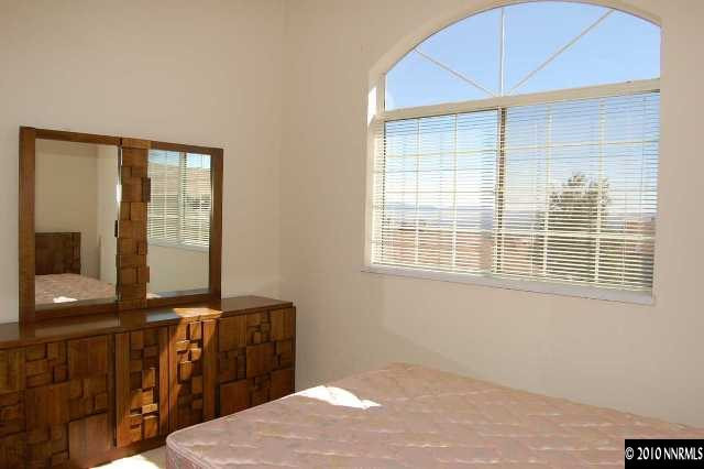 625 Talus Way Reno, NV 89503 - Photo 8 of 13 a bedroom with a bed and wooden floor