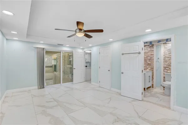 a bathroom with a granite countertop sink a toilet and shower