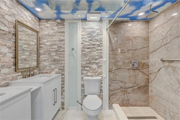 a bathroom with a double vanity sink mirror and