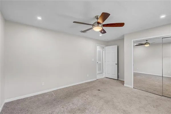a bathroom with a granite countertop sink toilet a shower and a mirror
