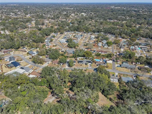 an aerial view of residential houses with city view