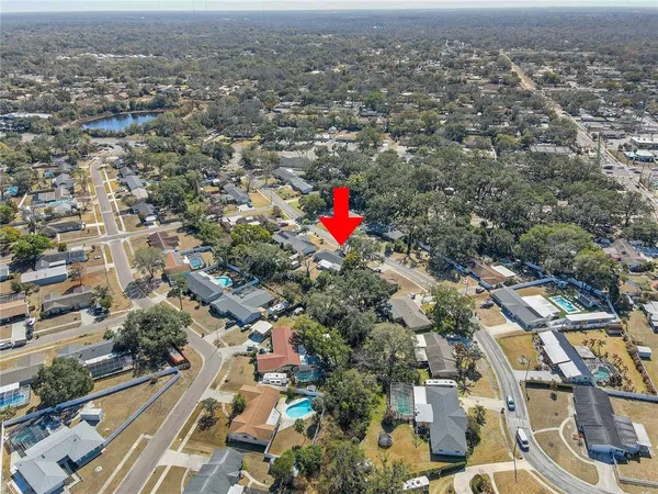 an aerial view of residential house with green space