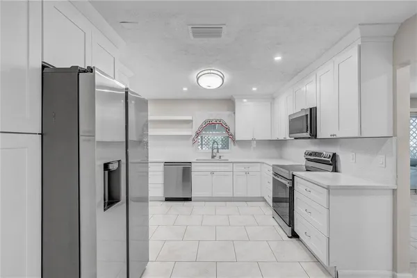 a kitchen with a refrigerator and a sink