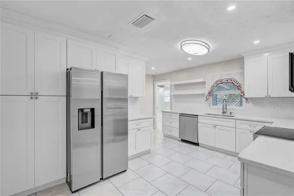 a kitchen with stainless steel appliances granite countertop a stove and a sink