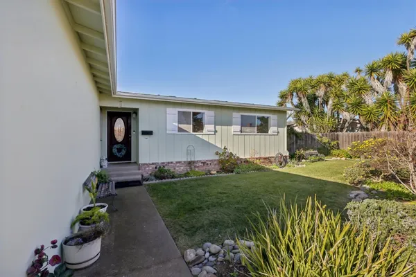 a front view of a house with a yard