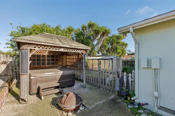 a view of a chair and table in backyard