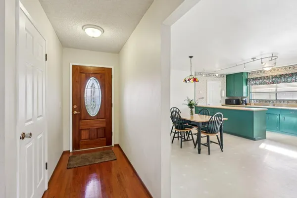 a dining room with furniture and a window
