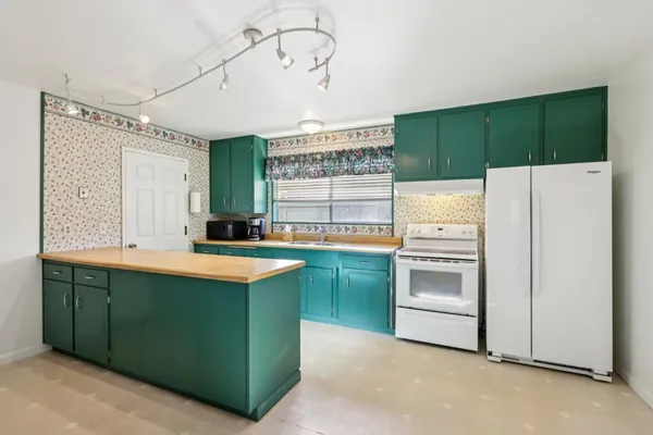 a kitchen that has a cabinets and a stove