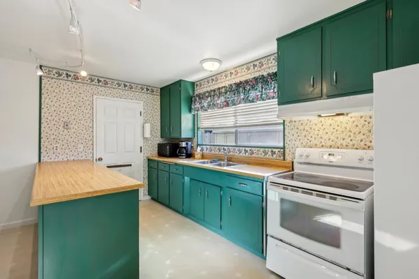 a kitchen that has a sink and a stove in it