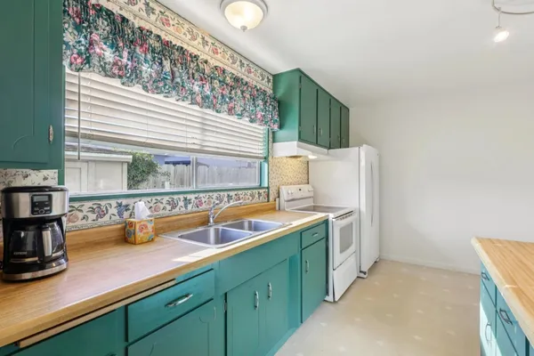 a kitchen with a sink and a stove