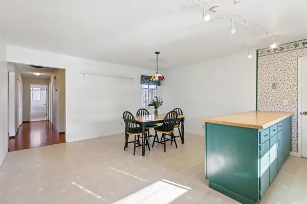a dining room with furniture and window