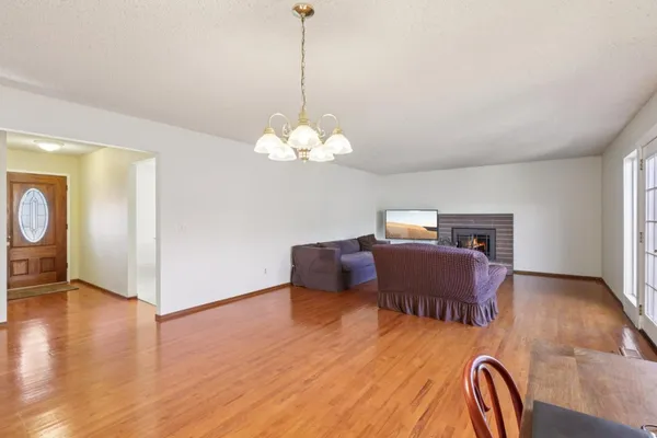 a bedroom with furniture and wooden floor