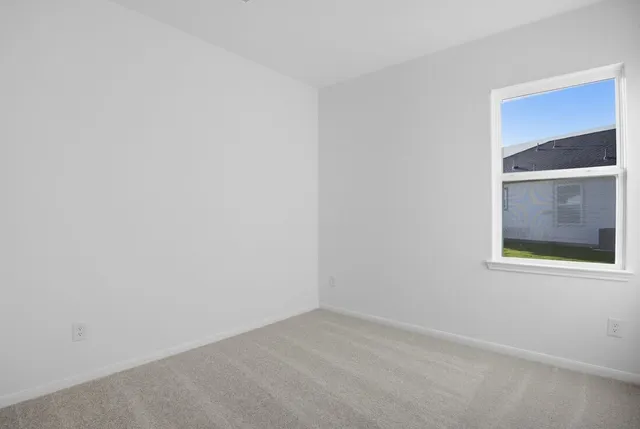 a view of a small space with wooden floor and a window