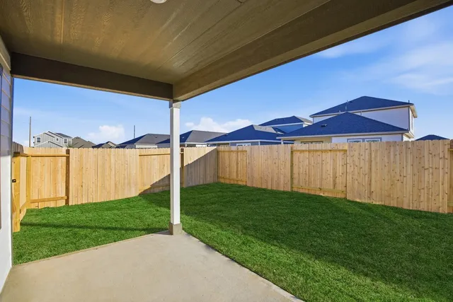 a view of a backyard with wooden fence