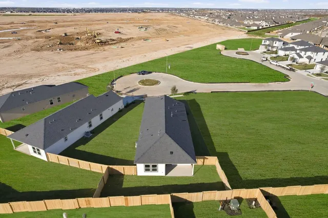 an aerial view of a house with swimming pool and outdoor seating