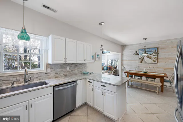 a kitchen with stainless steel appliances a refrigerator a stove a sink cabinets and a counter top space