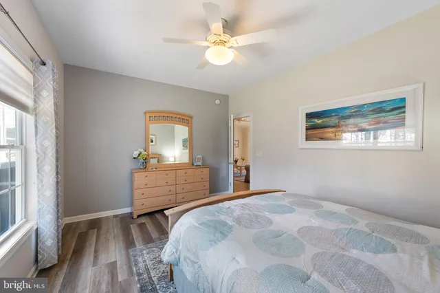 a bathroom with a granite countertop toilet sink and mirror