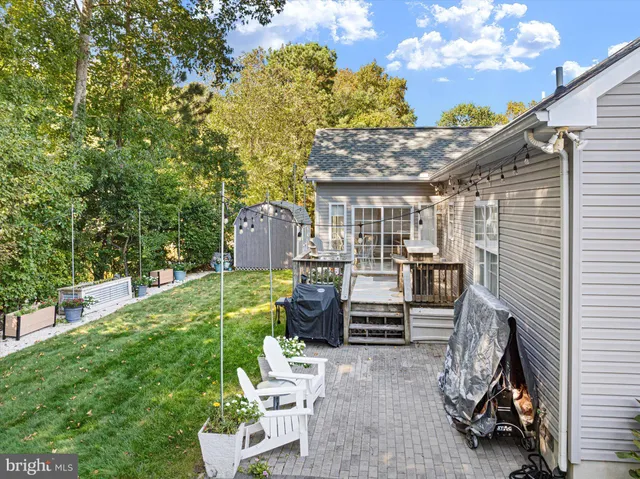 a view of a backyard with furniture and a garden