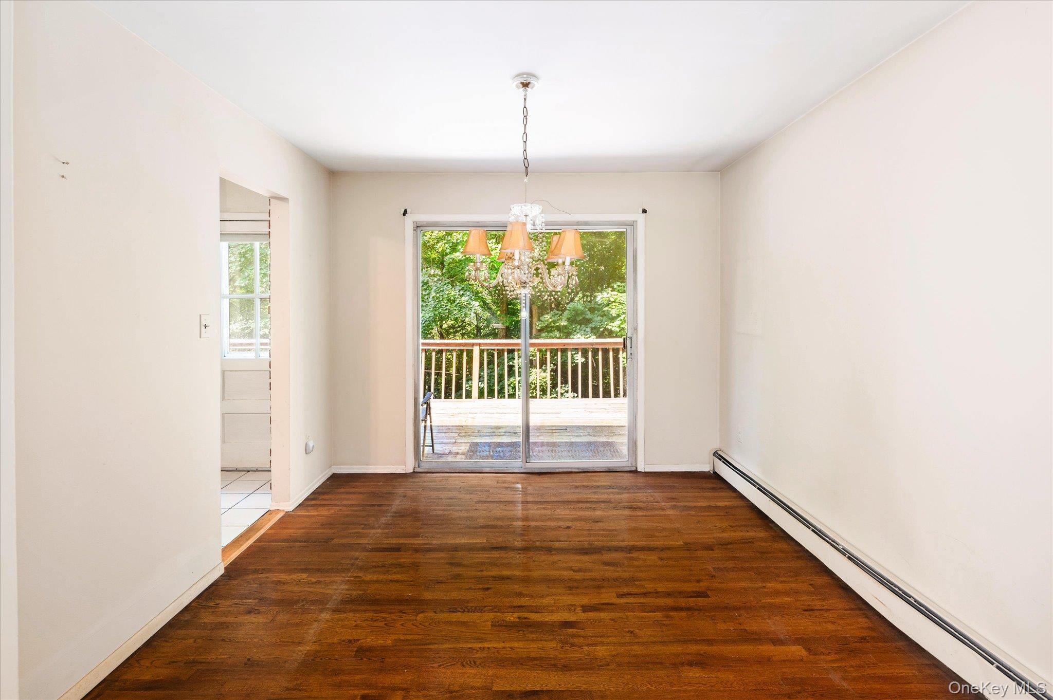 45 Laurelton Road Mount Kisco, NY 10549 - Photo 6 of 25 Dining Room with Sliders to the Deck and Opening to the Kitchen