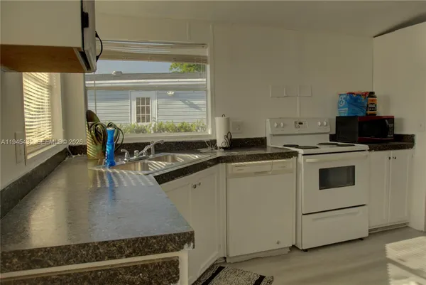 a kitchen that has a stove and a microwave