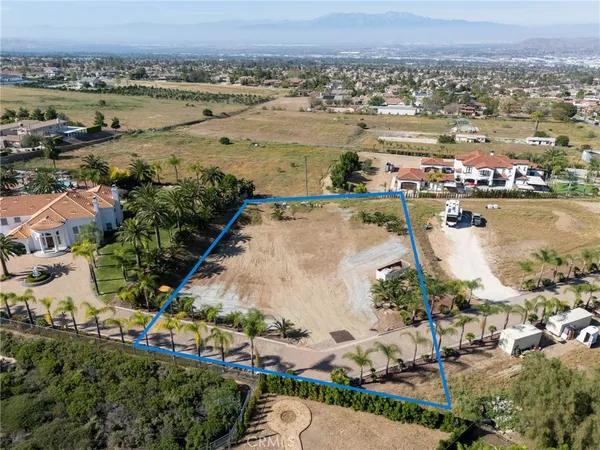 an aerial view of ocean and residential houses with outdoor space