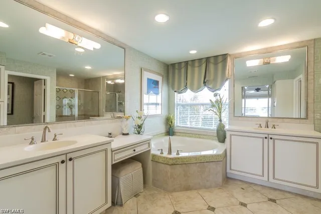 a bathroom with a large tub sink and mirror